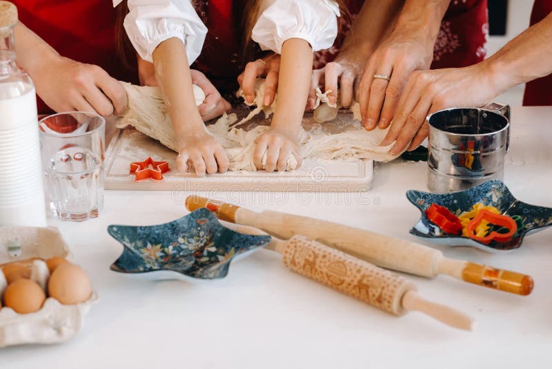 Close-up of hands cooking dough on the Christmas kitchen table stock photos