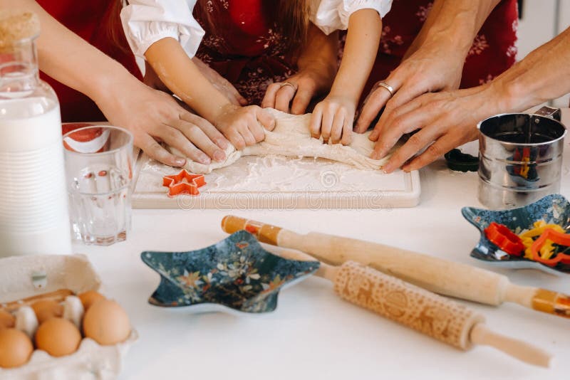 Close-up of hands cooking dough on the Christmas kitchen table royalty free stock photo