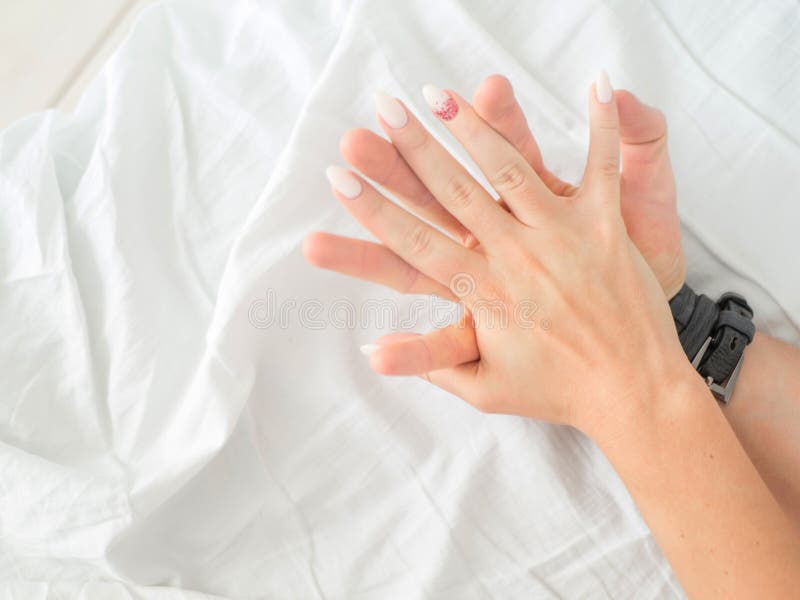 Close up hands of a couple make love hot sex on a bed royalty free stock photo Close up hands of a couple make love hot sex on a bed royalty free stock photo
