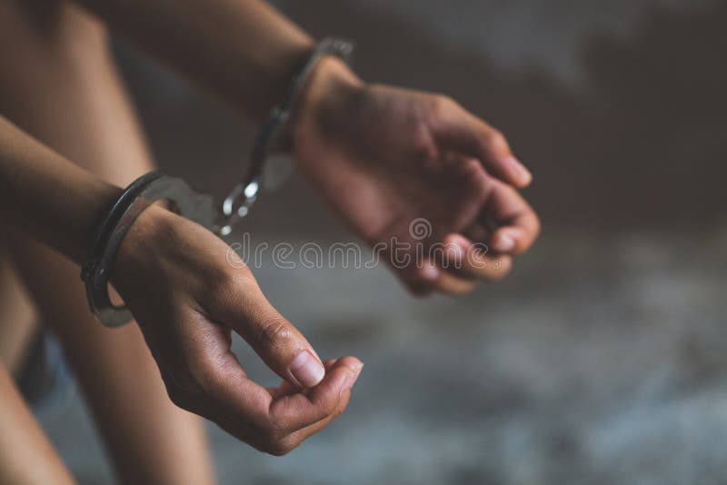 Close-up of hands in handcuff, Female prisoner, Arrested woman