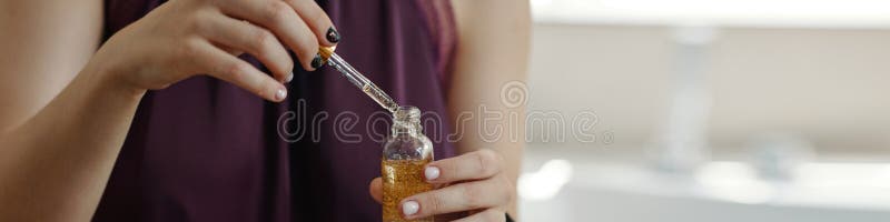 Dropping Serum into Small Bottle in Soft Lighting royalty free stock photography