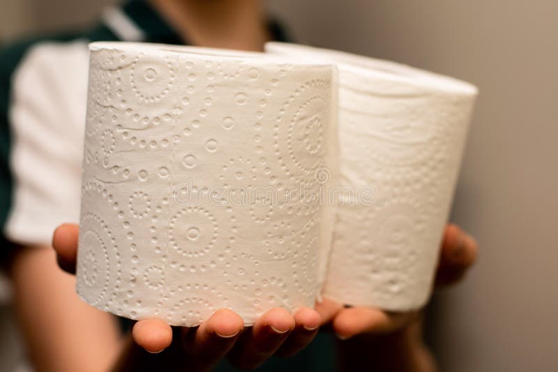 Close up of hands holding two toilet paper rolls royalty free stock images