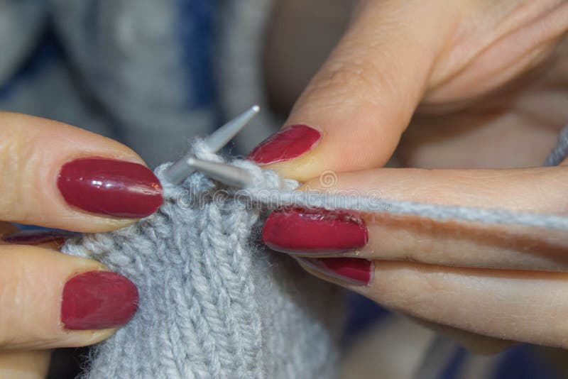 Close-up of hands knitting. People and needlework concept - woman hands knitting with crochet hook royalty free stock photo Close-up of hands knitting. People and needlework concept - woman hands knitting with crochet hook royalty free stock photo