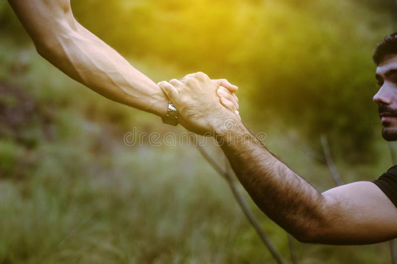 Page 8. Close up of hands man getting help to friends climb a rock,Helping hand...