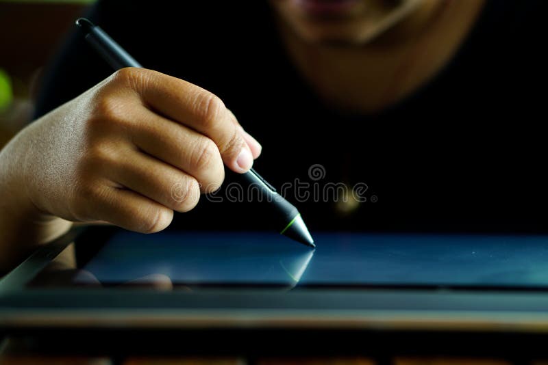 Close Up Hands with Pen Writing on the Modern Graphic Tablet Stock