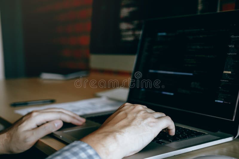 Close up hands of the software developers are sitting serious work analyzing data on the computer screen royalty free stock photography