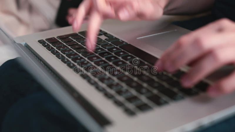 Close-up hands typing words laptop keyboard. Preparing text message in an e-mail