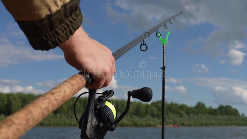 Close-up Hands of Unrecognizable Fisherman Lifting Fishing Rod from Holder  Checking Catch on River Bank. Calm and Stock Video - Video of closeup,  fisher: 266215645