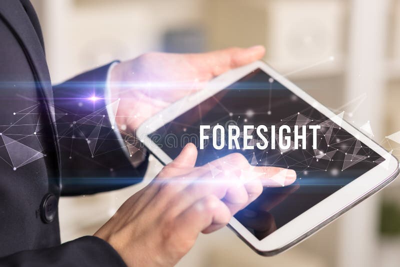 Close up hands using tablet with FORESIGHT inscription, modern business technology concept