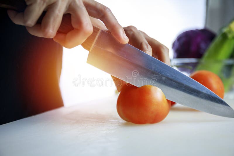 Female hand holding a cucumber with a spiral knife