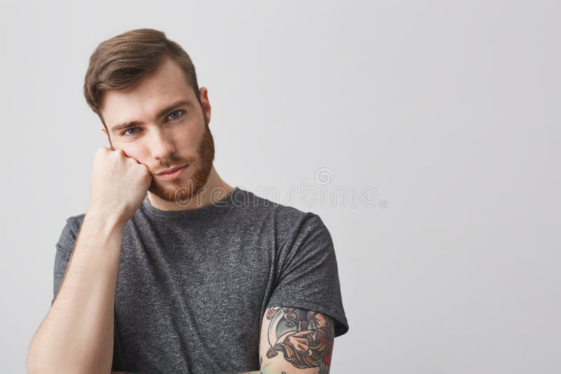 Close Up of Handsome Caucasian Man with Beard and Tattoo on Arm Holding Head with Hand, Looking in Camera with Bored Stock Photo - Image of bored, handsome: 103248110 Close Up of Handsome Caucasian Man with Beard and Tattoo on Arm Holding Head with Hand, Looking in Camera with Bored Stock Photo - Image of bored, handsome: 103248110