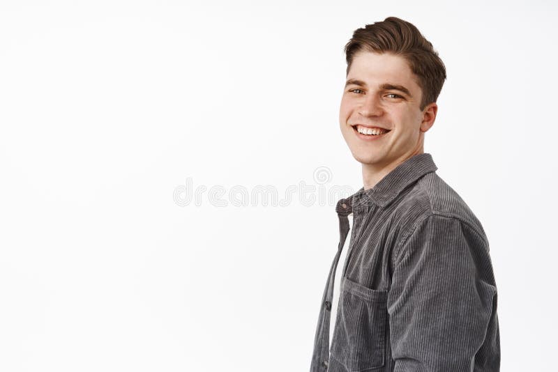 Close up of handsome happy candid boy, young man turn face at camera with white smile, positive cheerful face, looking