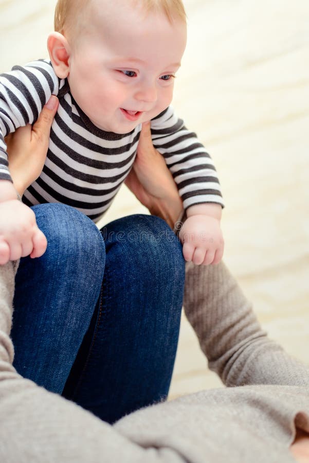 Close up of happy baby with playful parent stock images Close up of happy baby with playful parent stock images