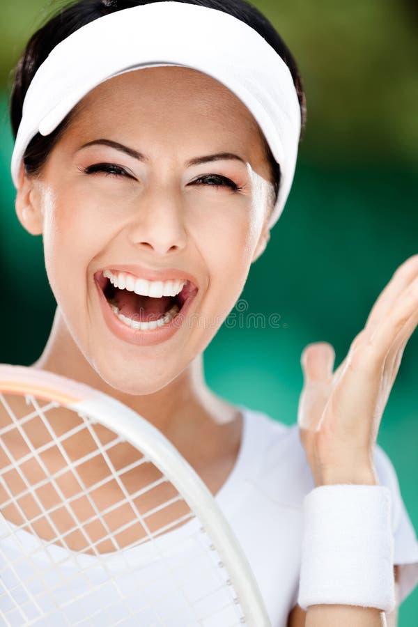 Close up of happy woman with tennis racket at the tennis court. Award. Close up of happy woman with tennis racket at the tennis court. Award