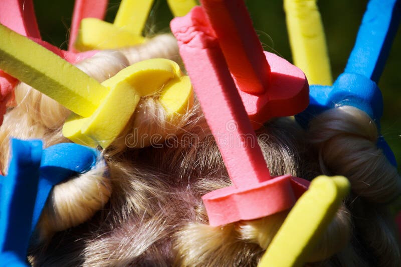 Close up of head of european woman with blonde hair and colorful old-fashioned foam curlers royalty free stock photo Close up of head of european woman with blonde hair and colorful old-fashioned foam curlers royalty free stock photo