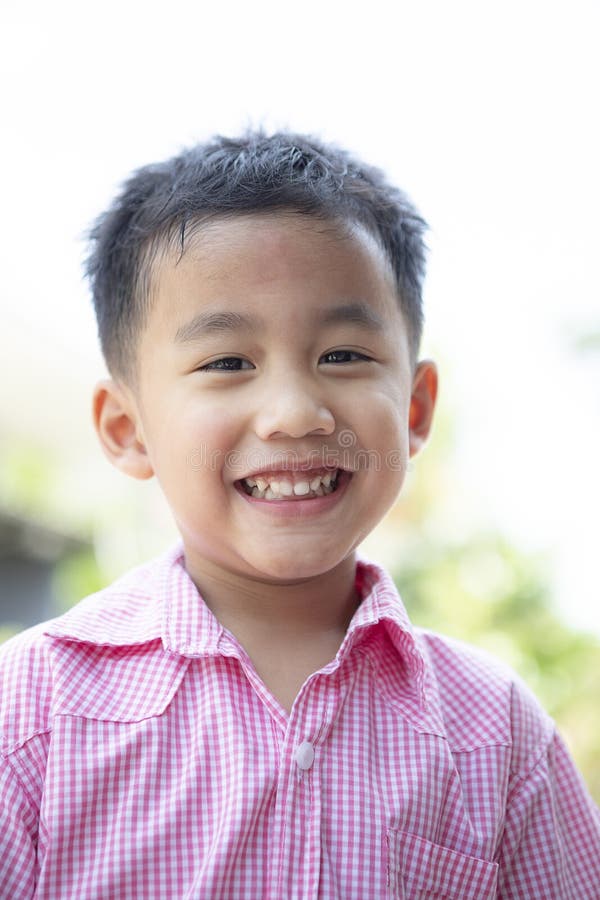 Close up headshot of cheerful asian children toothy smiling face of happiness emotion stock photography Close up headshot of cheerful asian children toothy smiling face of happiness emotion stock photography