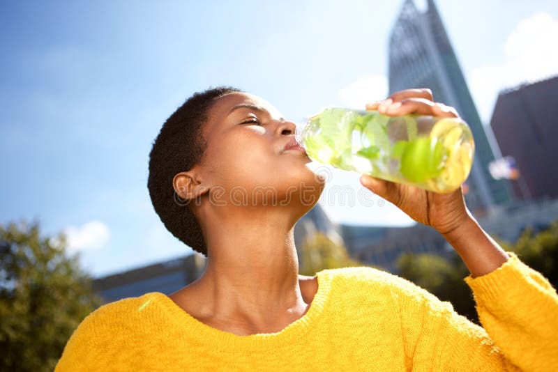 african woman drinking water