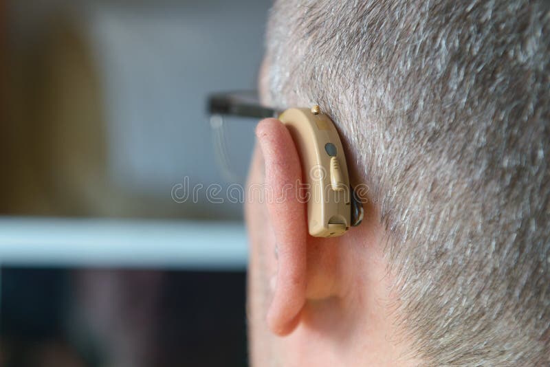 Close-up of a hearing aid worn by a deaf man royalty free stock photos