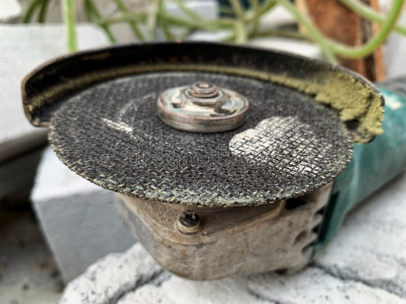 Close-up of heavy-duty angle grinder with worn cutting disc. royalty free stock photos