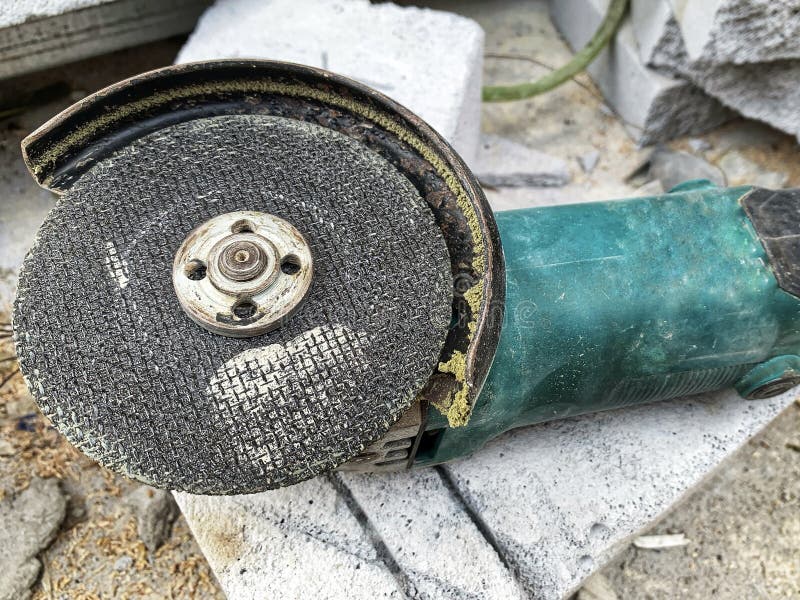 Close-up of heavy-duty angle grinder with worn cutting disc. royalty free stock photography