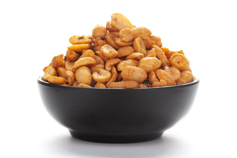 Close-up of Heeng jeera Peanuts mixture Indian namkeen snacks in black bowl over white background.