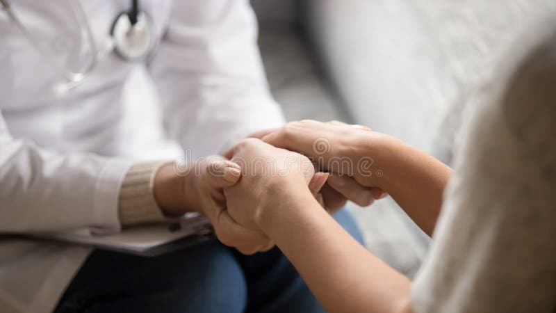 Close up horizontal image doctor holding hands of female patient stock images Close up horizontal image doctor holding hands of female patient stock images