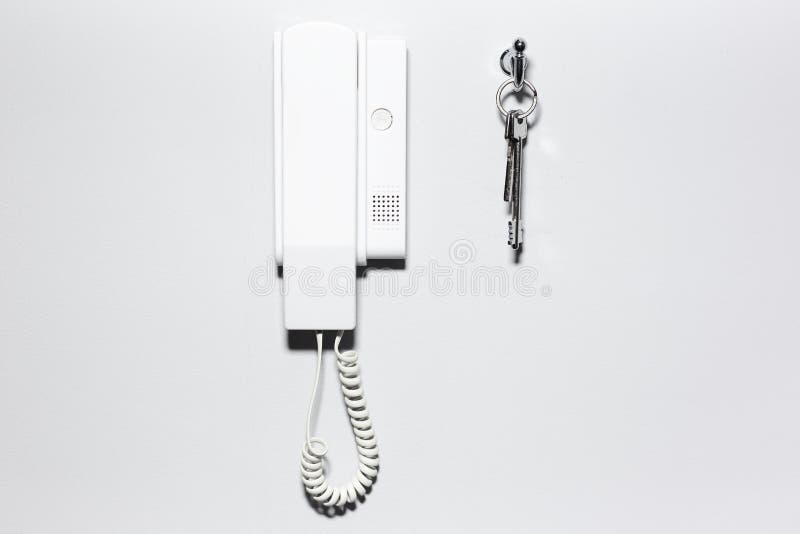 Close-up of house intercom and keys, on white wall background. royalty free stock image Close-up of house intercom and keys, on white wall background. royalty free stock image