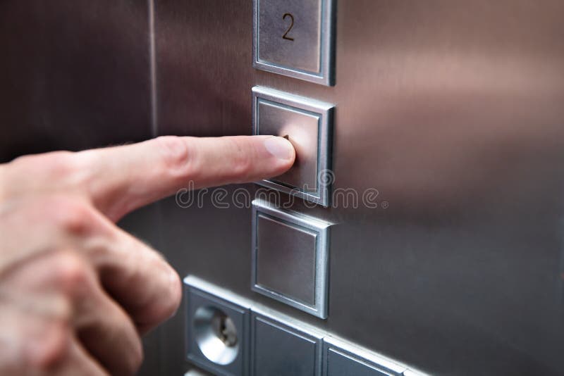 Human Finger Pressing Elevator Button stock photography