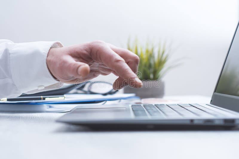 Close up of human hand using laptop computer on clean office desk. Business technology concept, remote work, digital communication, online services, modern workplace and professional workspace. Desk business concept stock images, royalty-free photos and pictures