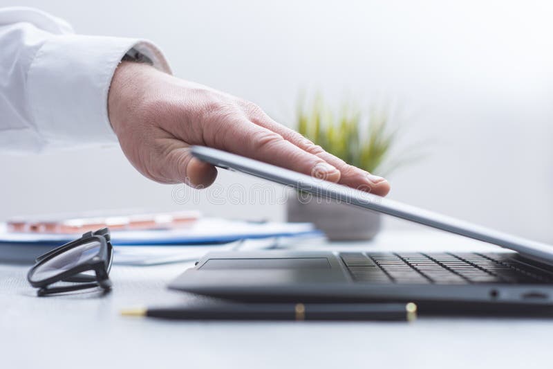 Close up of human hand using laptop computer on clean office desk. Business technology concept, remote work, digital communication, online services, modern workplace and professional workspace. Desk business concept stock images, royalty-free photos and pictures