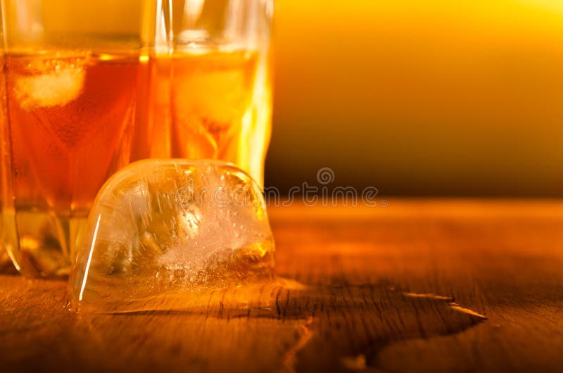 https://thumbs.dreamstime.com/b/close-up-ice-cube-melting-drink-away-to-over-wooden-table-gold-background-warm-colors-30827762.jpg