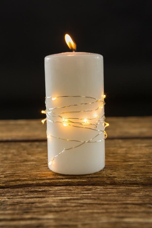 Lit tea candles and candles with copy space on black background Stock Photo  by Wavebreakmedia
