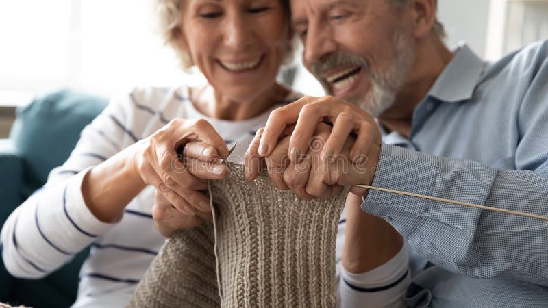 Close Up Image Elderly Wife Teaches Husband How To Knit ? photo photo