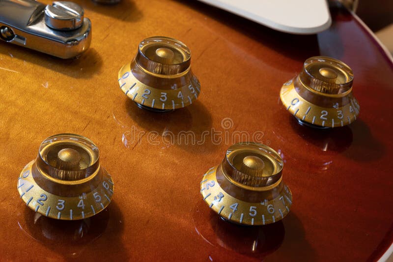 Closeup Image of an Electric Guitar with Shiny Knobs Stock Photo