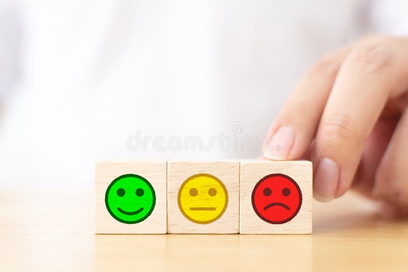 Close up image hand of customer choose sad face sign on wooden cube block stock image