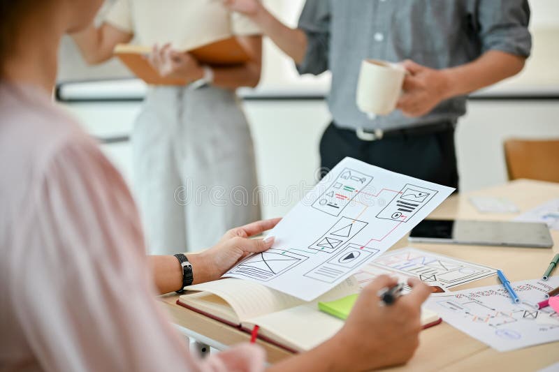 Close-up image of a professional female UI developer is in the meeting with her colleagues royalty free stock image