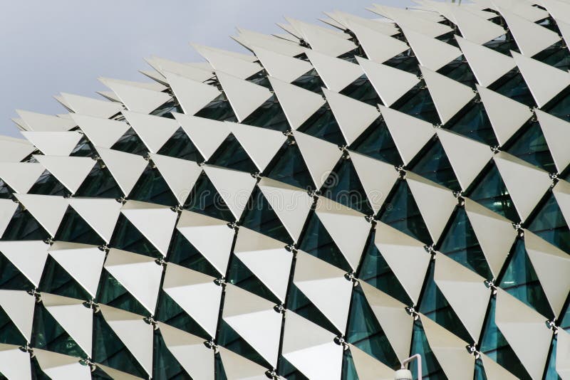 Close up image showing detail of the roof of a building showing windows and triangular panels in a pattern