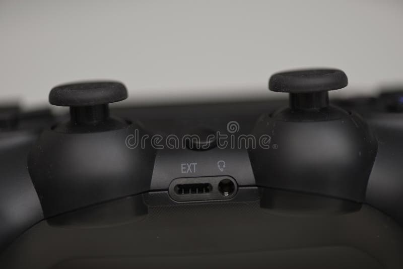 Close up of black game controller top view with dual analog joysticks and expansion port isolated on light background stock photo