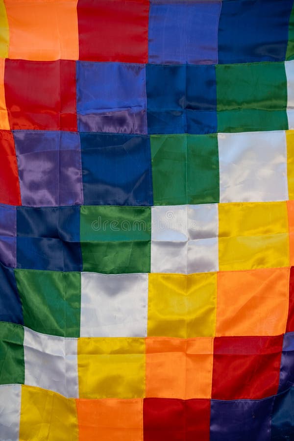 Close up image of a silk Wiphala Flag - a symbol commonly used to represent native peoples of the Andes. vertical photo stock photos