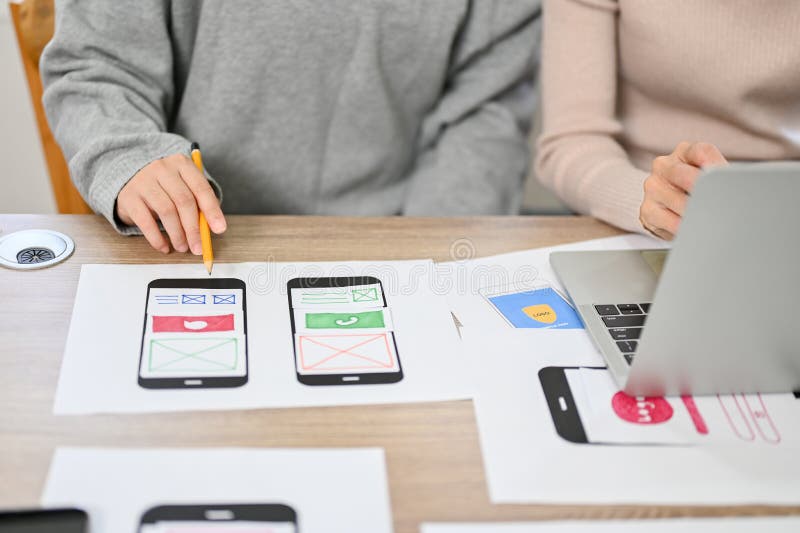 Close-up image, Team of professional mobile application developers checking their new prototype. Close-up image, Team of professional mobile application developers checking and testing their new prototype in the meeting