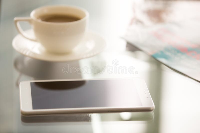 Close up image of trendy smartphone on glass desk stock images Close up image of trendy smartphone on glass desk stock images