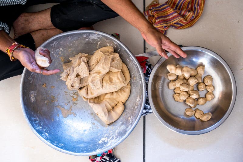 Close up of indian man hands making roti dough in pot with soft natural light with a sense of intimacy and cosy royalty free stock photography Close up of indian man hands making roti dough in pot with soft natural light with a sense of intimacy and cosy royalty free stock photography