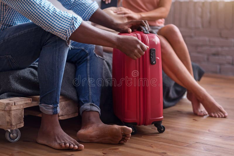 Close up of international couple packaging for a journey stock photo Close up of international couple packaging for a journey stock photo