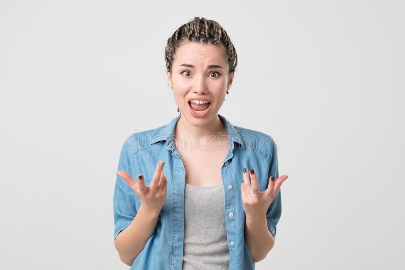 Close up isolated portrait of young caucasian annoyed angry woman holding hands in furious gesture. stock photos Close up isolated portrait of young caucasian annoyed angry woman holding hands in furious gesture. stock photos