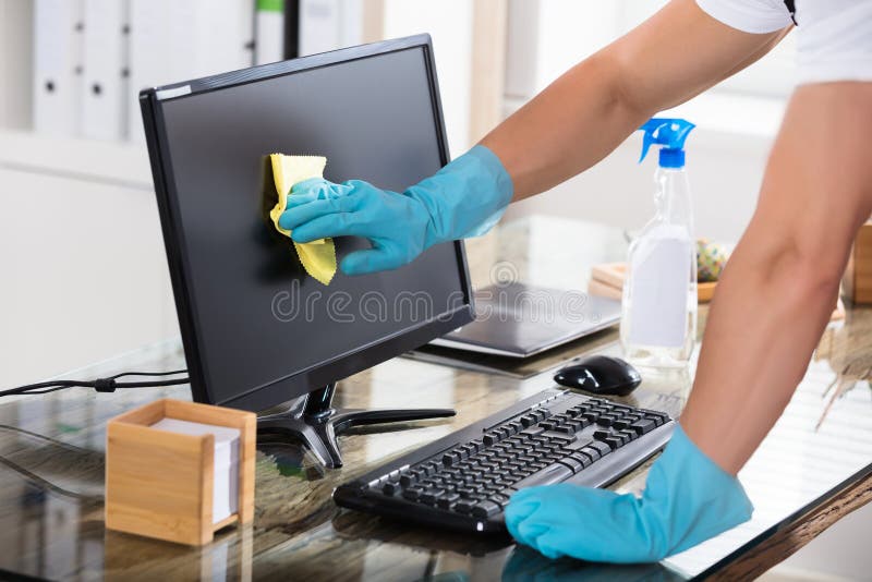 Close-up Of A Janitor Cleaning Computer Screen stock photo