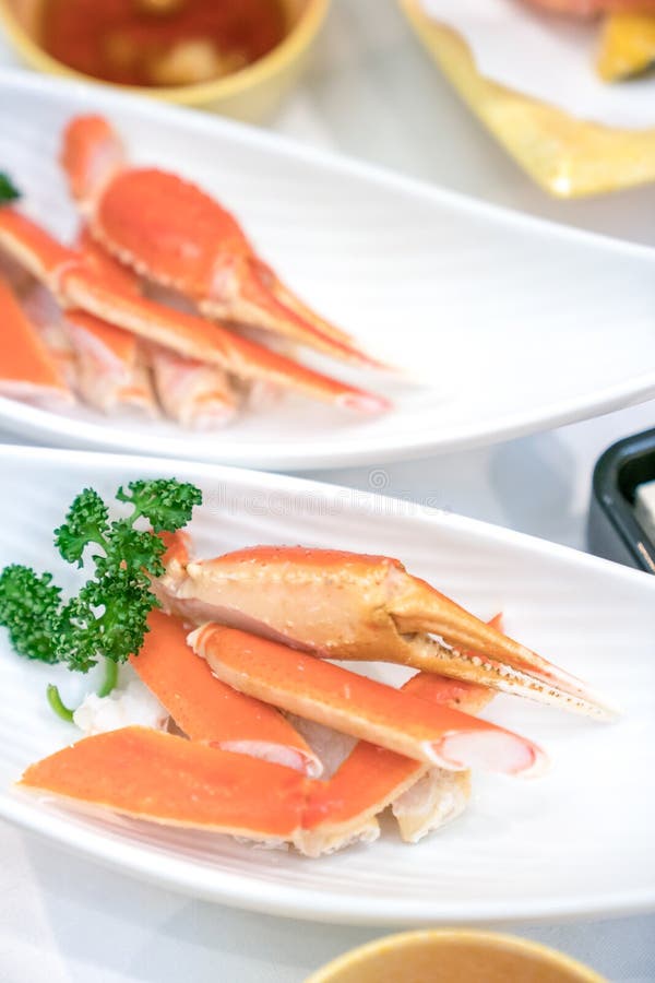 Close up Japanese claw and leg steamed crab on white dish, decorate with vegetable beside stock image Close up Japanese claw and leg steamed crab on white dish, decorate with vegetable beside stock image