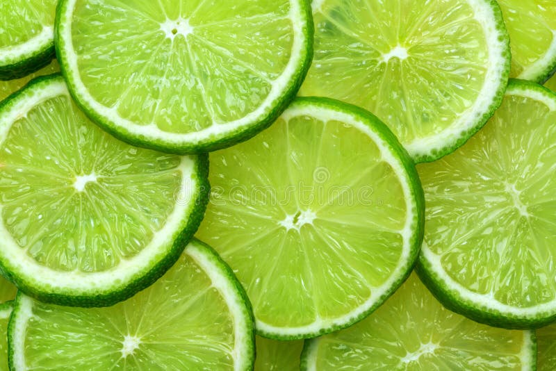Close-up juicy Lime slices abstract background in pastel green color. Bright summer texture. Close-up juicy Lime slices abstract background in pastel green color. Bright summer texture.