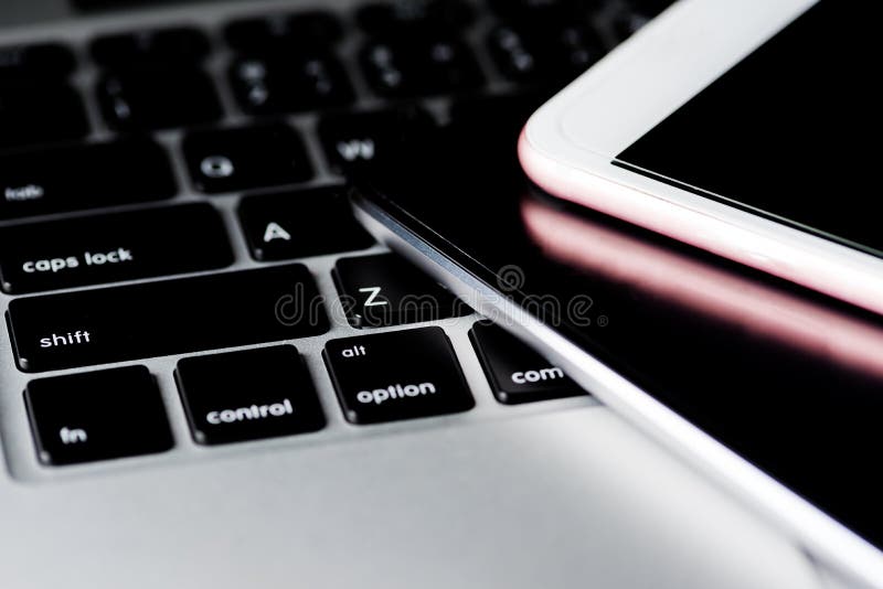 Close up of a keyboard computer with phone and tablet background royalty free stock photo Close up of a keyboard computer with phone and tablet background royalty free stock photo