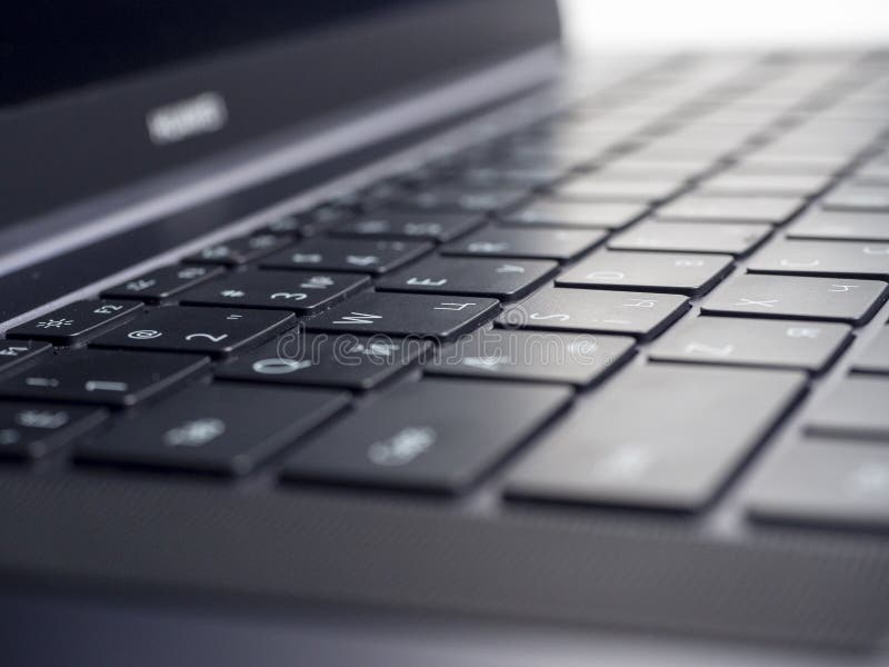 Close-up of the keyboard of an open laptop. Selective focus. Modern devices for work and leisure.