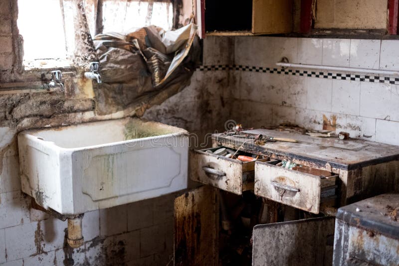 Close up of kitchen left in appalling condition in derelict 1930s deco house. Rayners Lane, Harrow UK